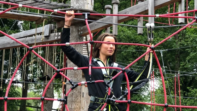 erson klettert auf einem Netz-Parcours im Kletterpark Biggesee.