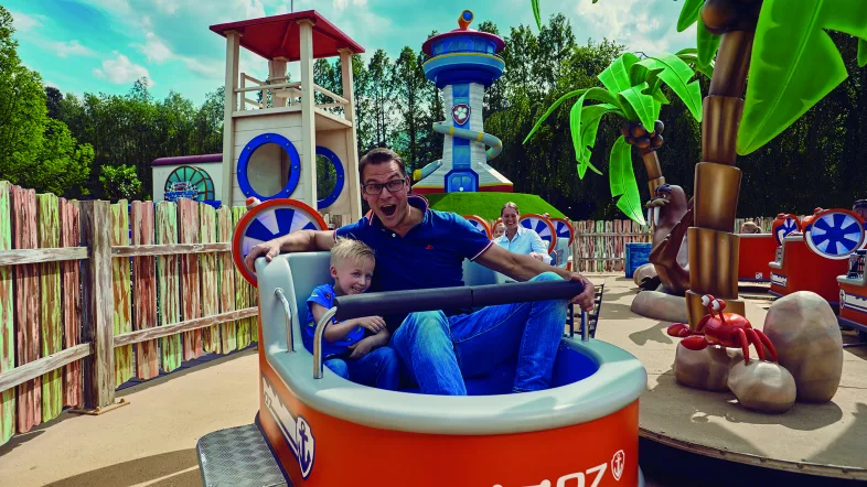 Ein Vater fährt in einem Karussell mit seinem Sohn im Movie park bottrop.